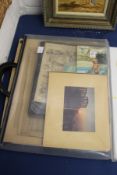 A folder containing various postcards, prints, photographs etc.