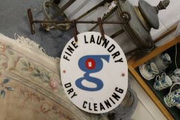 A wrought iron bracket with Dry Cleaning sign.