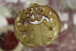 A Chinese armorial shaped carved jade pendant.