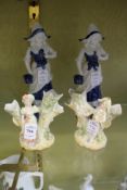 Two pairs of porcelain figure groups.