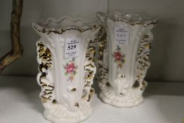 A pair of floral decorated vases.