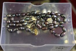 An iridescent pearl necklace.