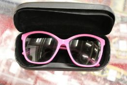 A pair of Dolce and Gabbana pink sunglasses, boxed.