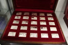 A cased set of twenty five cast silver ingots commemorating Queen Elizabeth II.