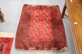 A small Persian Bokhara style rug.