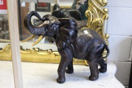 A large continental bronze glazed pottery model of a bull elephant.