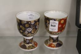 A pair of Imari decorated porcelain pedestal cups.