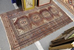 A Persian rug (worn).