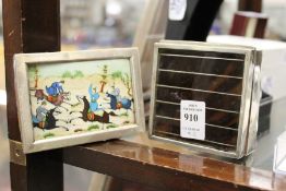 A silver cigarette box and photograph frame.