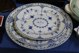 Three blue and white oval serving dishes.