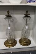 A large pair of cut glass and brass lamp bases.