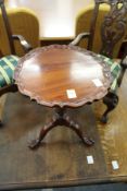 A Chippendale style miniature mahogany tilt top tripod table.