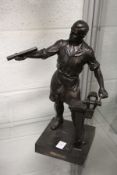 A continental spelter model of a workman stood beside a vice.
