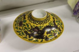 A Chinese famille jaune porcelain dragon bowl and cover.