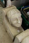 A large reconstituted stone human head corbel.