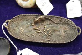 A decorative cast metal dish.