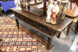 AN 18TH CENTURY SPANISH OAK SERVING TABLE with a single plank top, three carved frieze drawers on