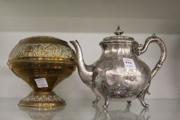 A teapot and a brass flower bowl.