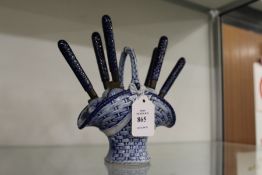 An unusual Dutch blue and white porcelain vase containing six fruit knives.