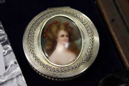 A good continental silver circular box, the hinged lid inset with a painted porcelain plaque of a