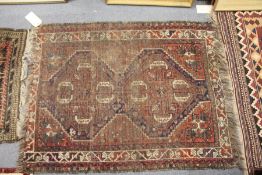 A small Persian rug (worn).