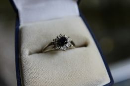 An 18ct gold diamond and sapphire ring.