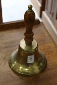 A brass hand bell.