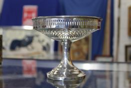 A silver pedestal dish with pierced decoration.