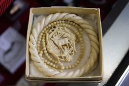 Various carved jewellery.