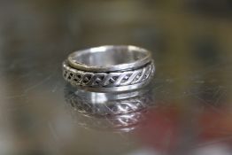 A decorative silver ring.