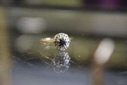 An 18ct gold diamond and sapphire ring.