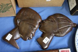 Two carved hardwood portrait plaques.