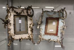 A pair of decorative photograph frames, the frames moulded with birds on branches.