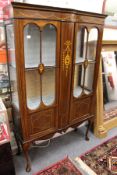 An Edwardian inlaid mahogany two door display cabinet.