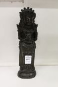 A dark patinated bronze figure of an eastern deity.