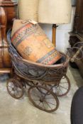 A Victorian style doll's pram.