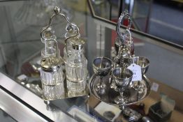 A plated four place egg cruet and a plated and cut glass condiment set.