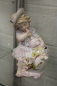 A continental vase modelled as a young girl seated playing pipes.
