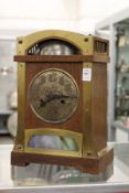 An oak cased Arts & Crafts mantle clock made for Liberty's, with a domed top case, exposed bell,