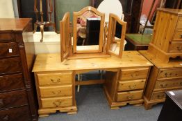 A pine pedestal dressing table and mirror.