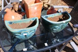 A pair of glazed wall planters.