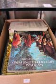 A box of art and antique reference books.