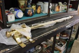 Brass curtain pole with rings and brackets.