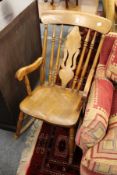 A Victorian beech and elm Windsor rocking chair with arms.