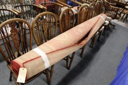 A modern machine made red ground carpet.