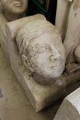 A large reconstituted stone human head corbel.