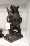 A good Black Forest style carved wood model of a hiking bear.