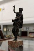 A small classical bronze figure on a marble base.