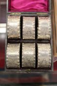 A cased set of six engraved silver plated plated napkin rings.