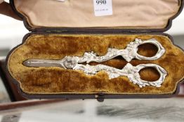 A cased set of ornate grape scissors.